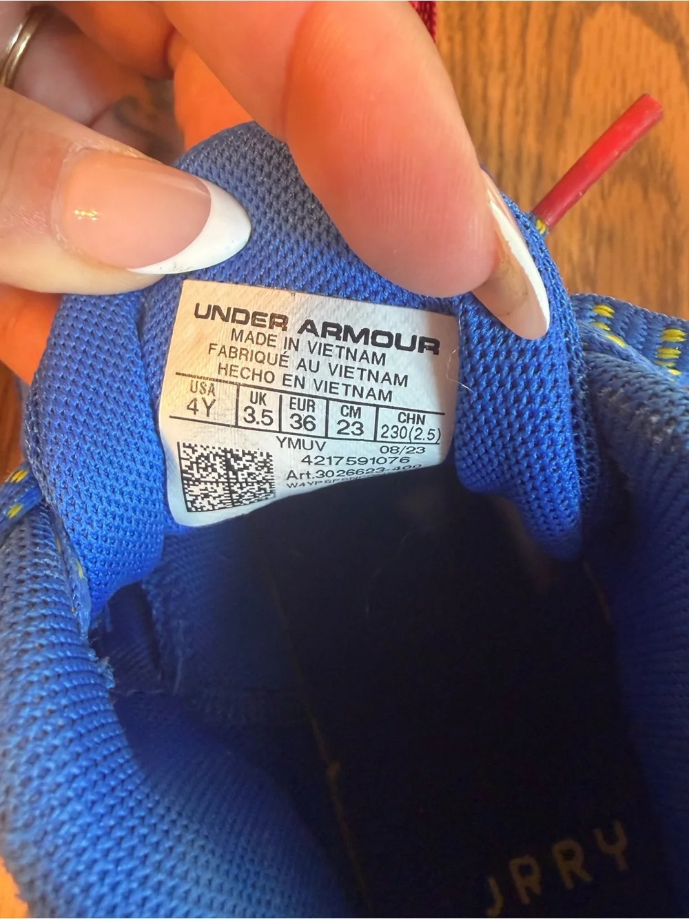 Under Armour Kids Blue Sneakers with Yellow and Red Accents